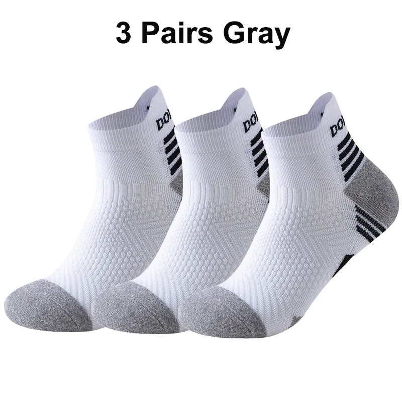 Three pairs of gray running socks with a brand logo on a white background