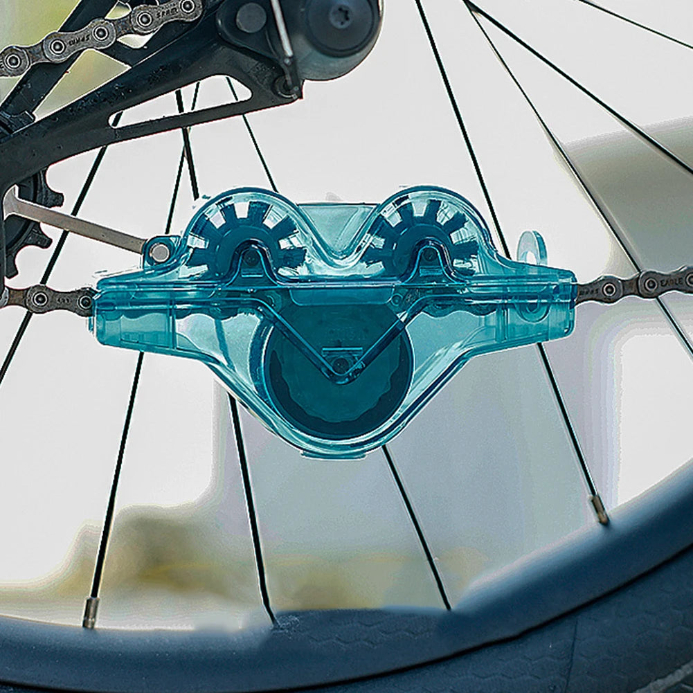 Blue bike chain tensioner attached to a bicycle chain on a blurred background