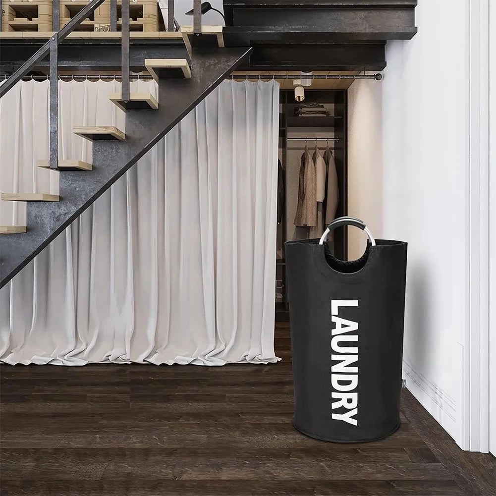 Black laundry bag with 'LAUNDRY' text in a modern interior setting.