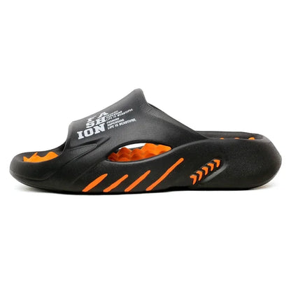 Black sandal with orange accents on a white background