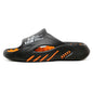 Black sandal with orange accents on a white background