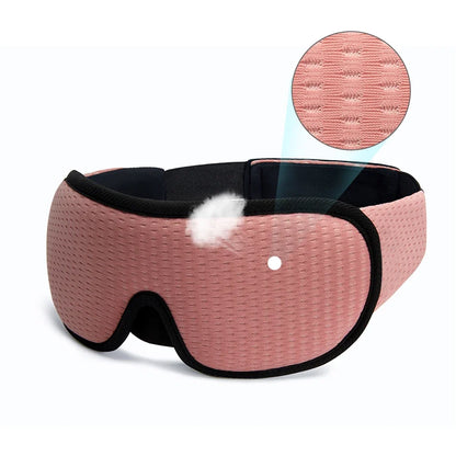 Pink sleep mask with black straps on a white background