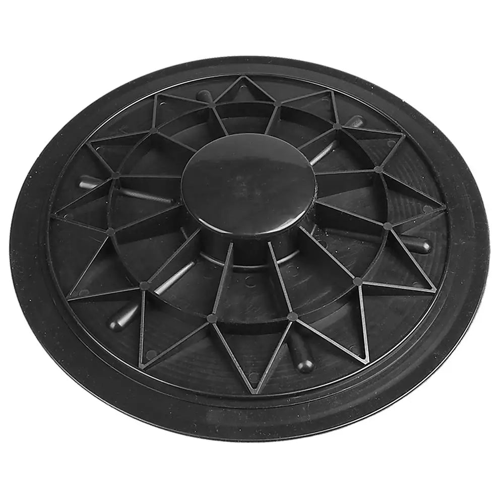 Black plastic balance disc with geometric design on a white background