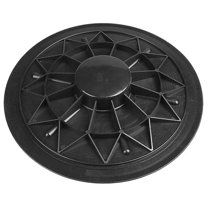 Black plastic balance disc with geometric design on a white background