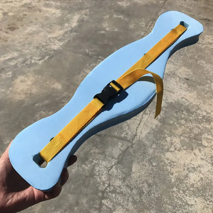 Blue water belt with yellow straps held by a hand on a concrete surface