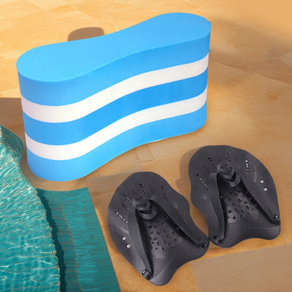 Blue and white striped pool float and black swim paddles on a wooden surface near a pool.