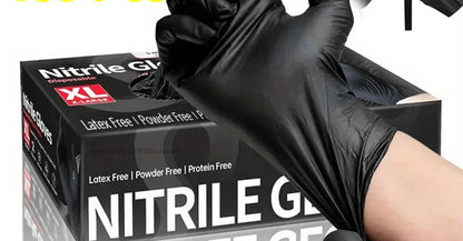 Black nitrile gloves with packaging and a hand wearing a glove, on a white background.