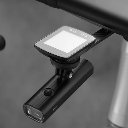 Black Garmin attached to a bicycle handlebar with a blurred background