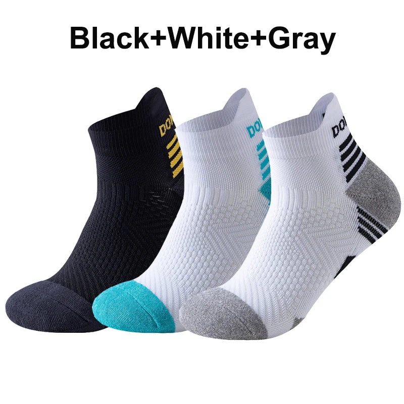 Three pairs of running socks in black, white, and gray with brand logos on a white background.