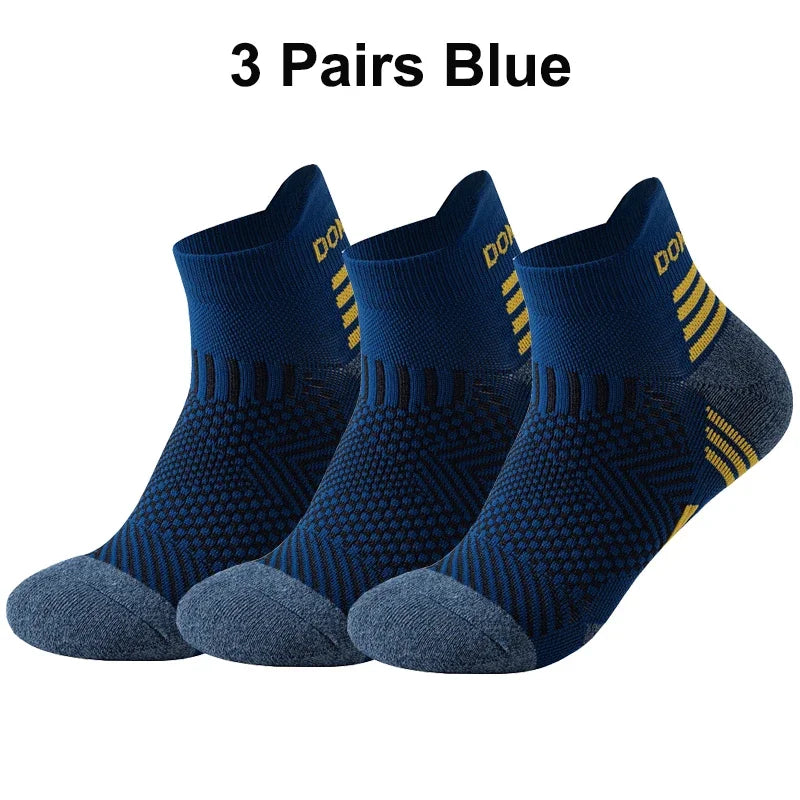 Three pairs of blue running socks with yellow stripes on a white background