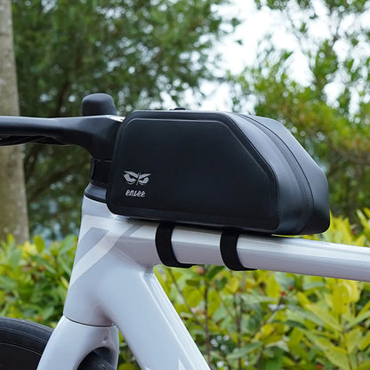 Bicycle handlebar with a black bag and 'enve' branding against a green foliage background