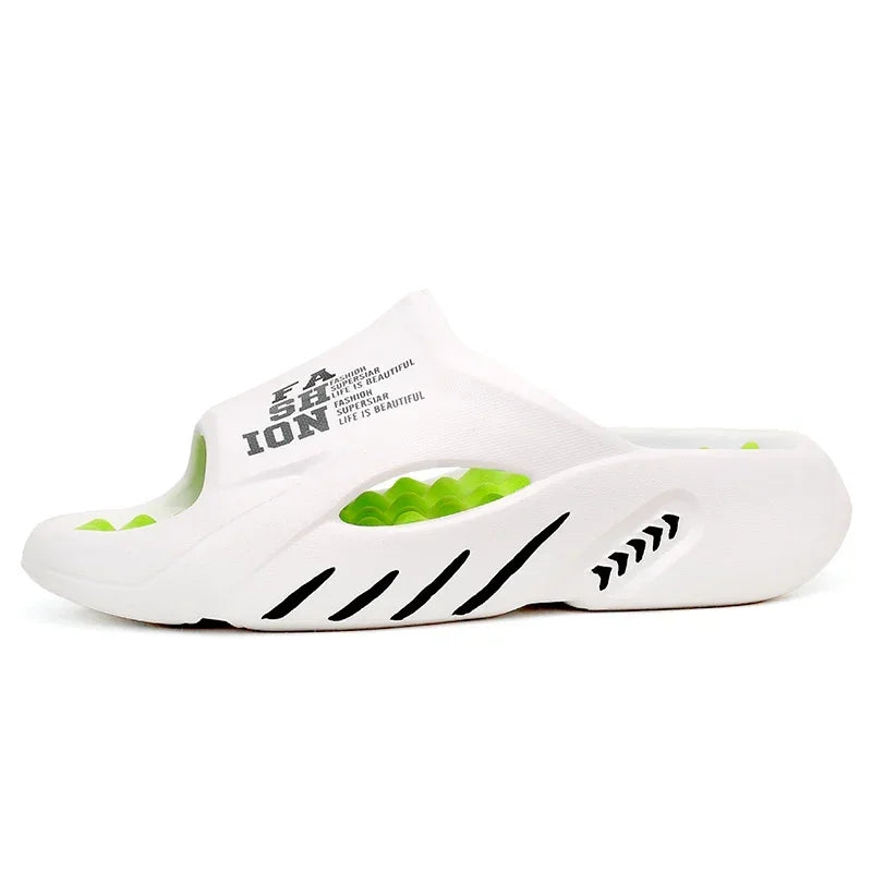 White slide sandal with green accents and branding on a white background