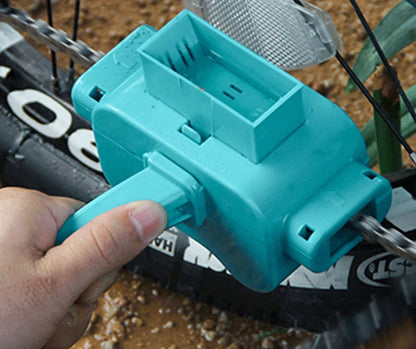 Turquoise chain cleaning tool held by a hand with a blurred background