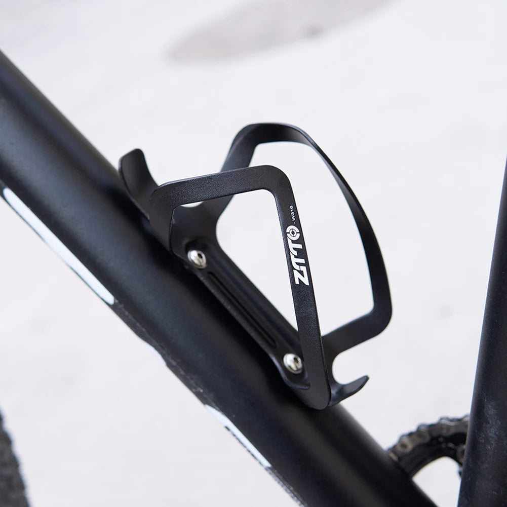 Black bicycle water bottle holder on a bike frame with 'LUZ' branding.