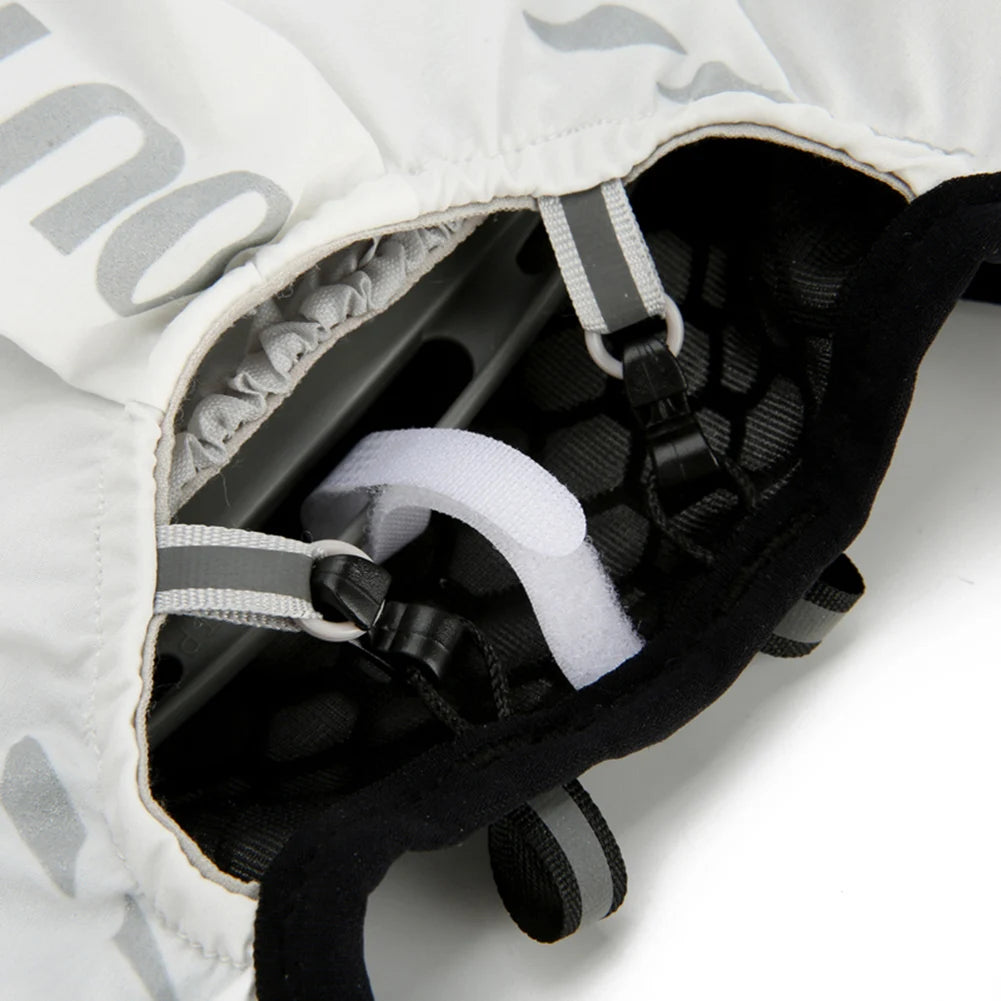 Close-up of a black and white helmet with straps on a white background