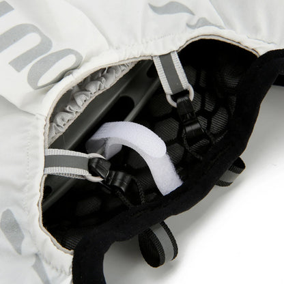 Close-up of a black and white helmet with straps on a white background