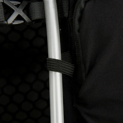 Close-up of a black backpack with a white pole and hexagonal pattern