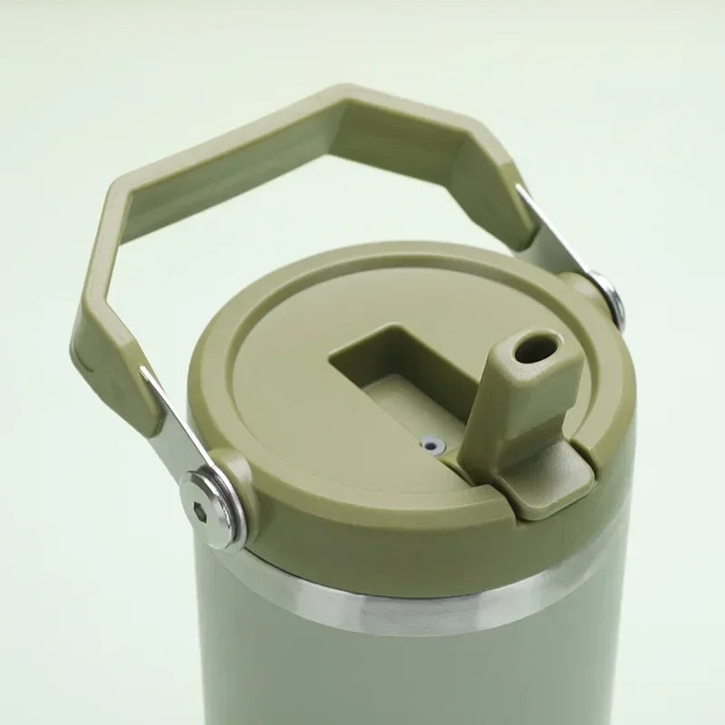 Green insulated mug with a handle on a light gray background