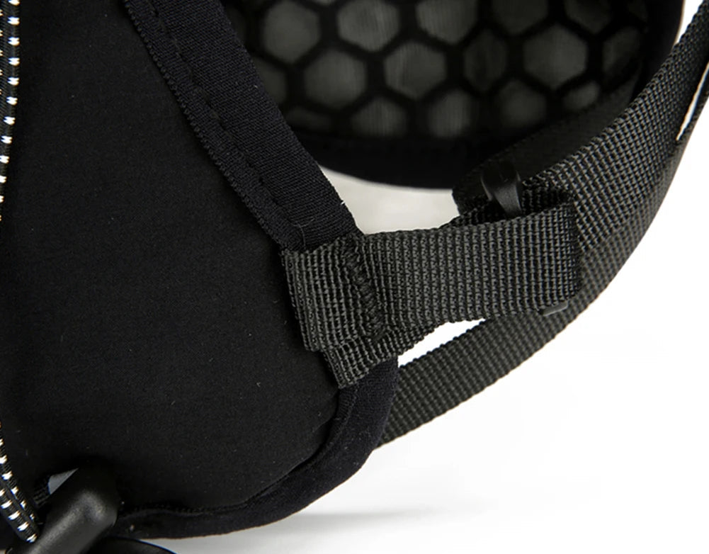 Close-up of a black helmet with a detailed strap design on a white background