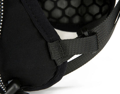 Close-up of a black helmet with a detailed strap design on a white background