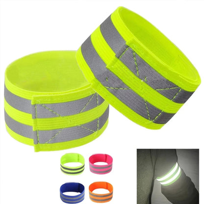 Two neon green reflective arm bands with gray stripes on a white background.