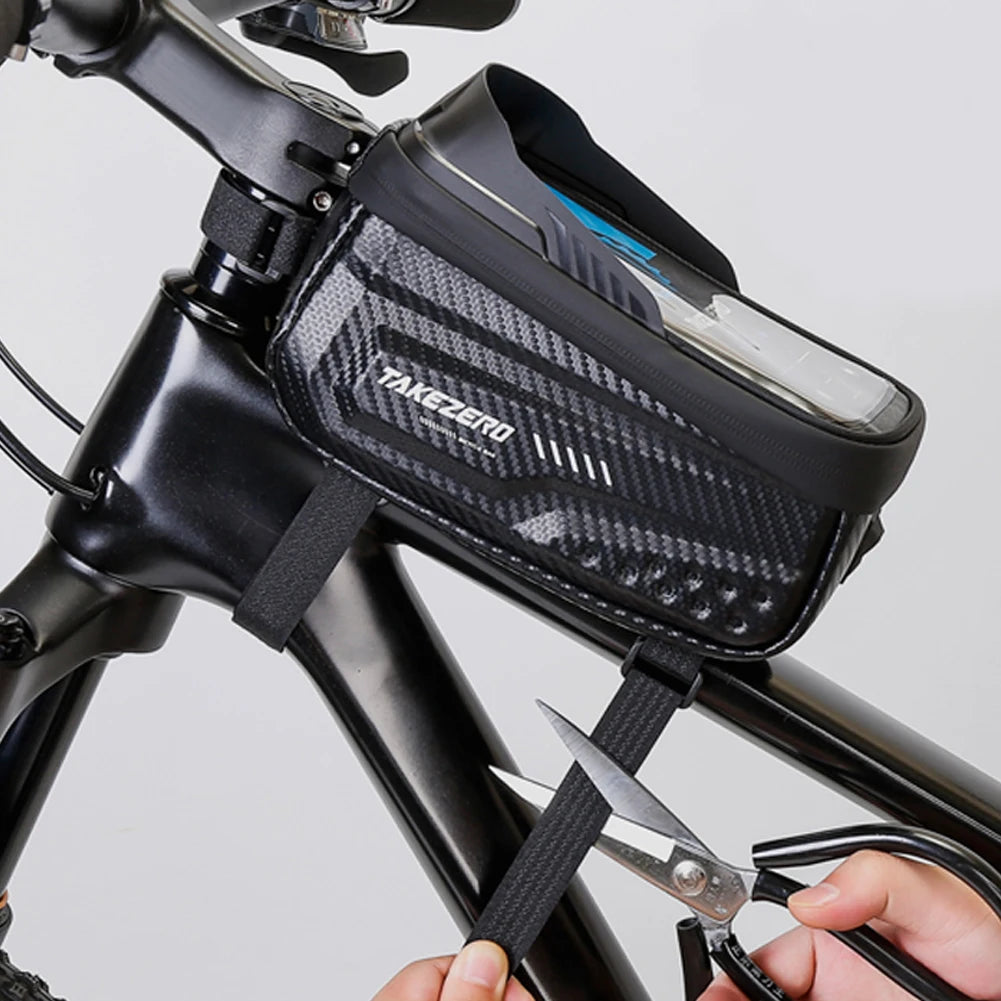 Bicycle frame bag with a phone inside, being cut open by scissors.