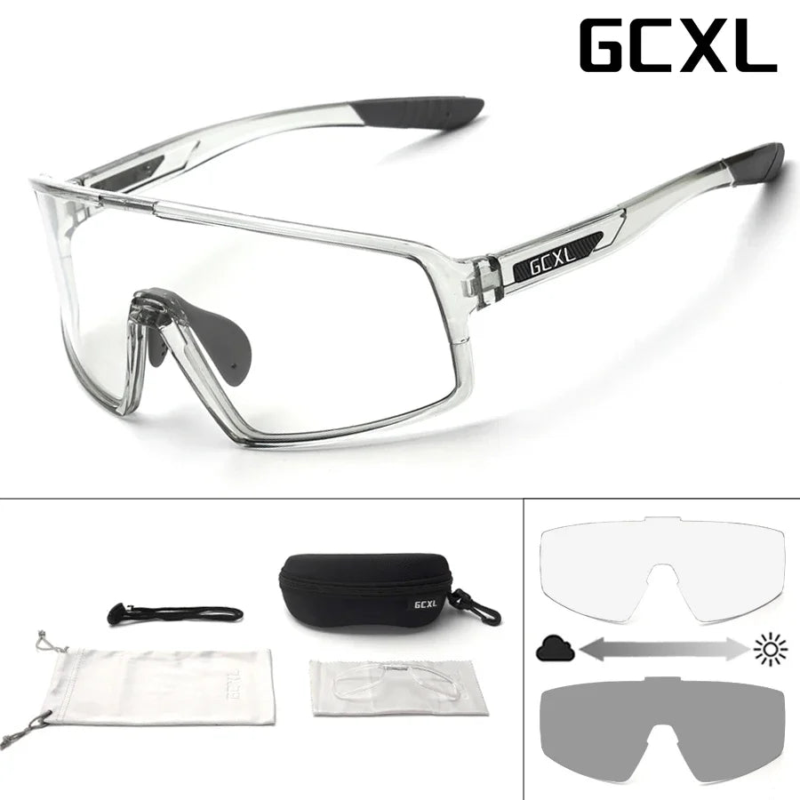 Clear safety glasses with black accents and GCXL branding, including additional lenses and case on a white background.