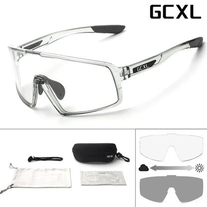 Clear safety glasses with black accents and GCXL branding, including additional lenses and case on a white background.