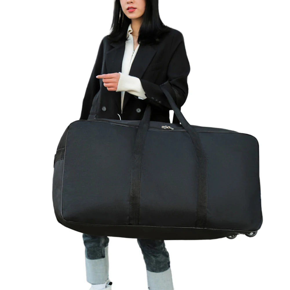 Person holding a large black travel bag on a white background