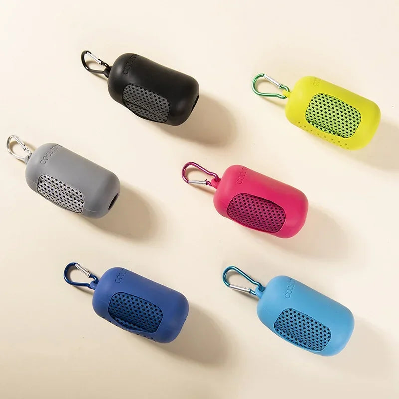 Colorful keychain towels with carabiners on a beige background