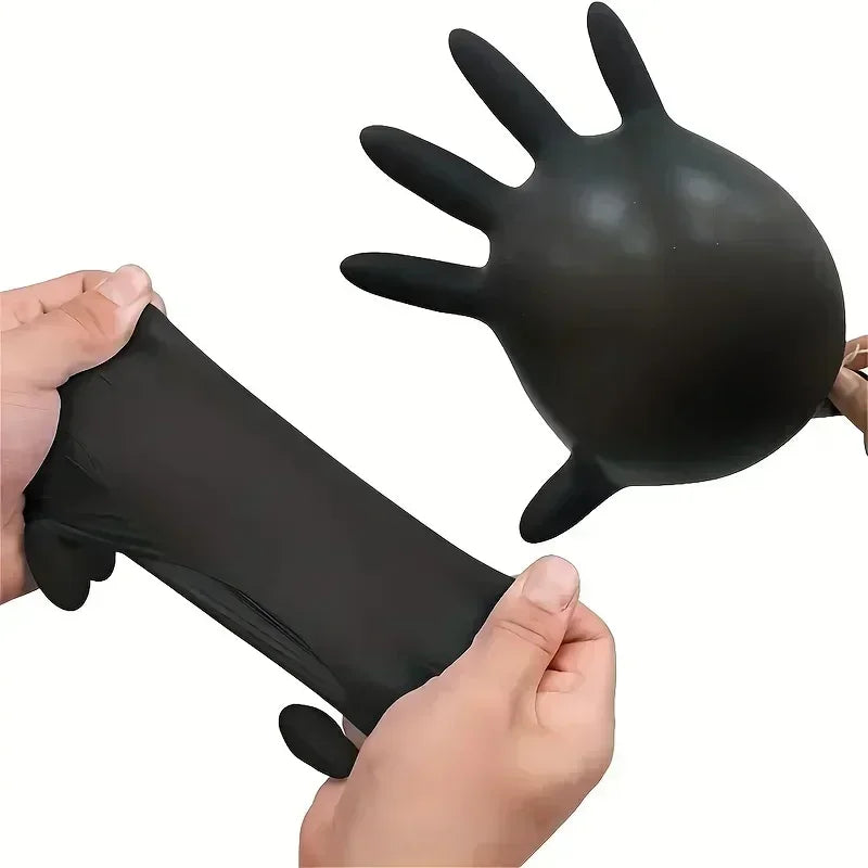 Black latex glove being stretched by hands on a white background