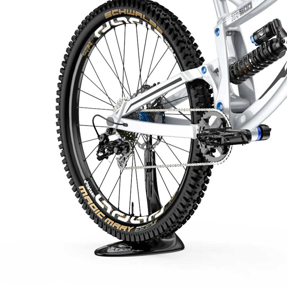 Close-up of a bicycle wheel with 'Maxxis' tires on a white background