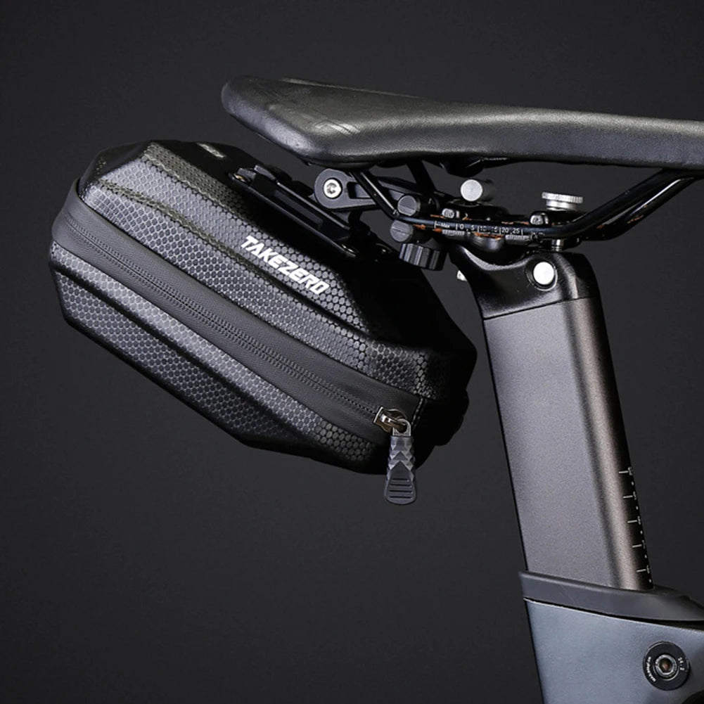 Black saddle bag attached to a bicycle seat on a dark background