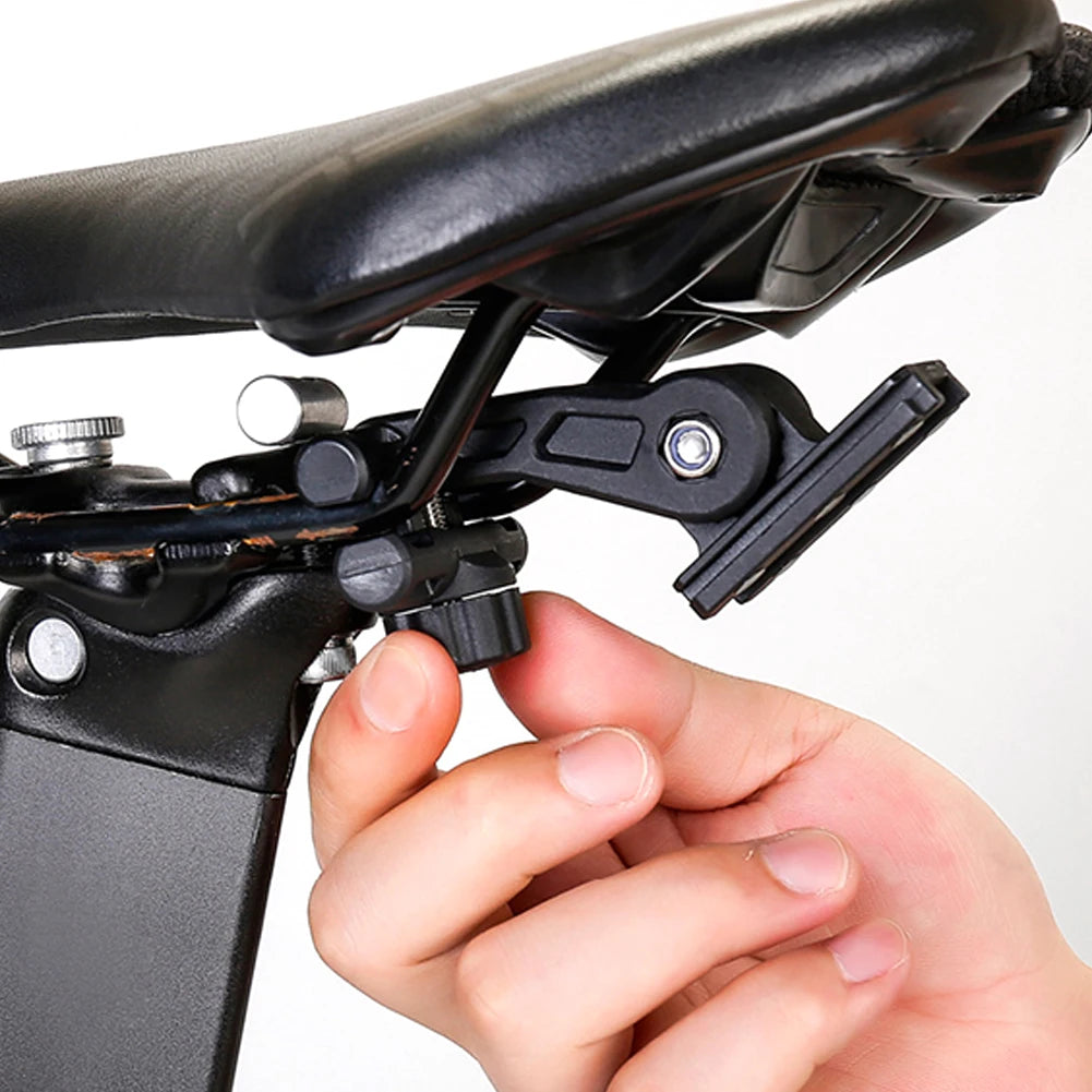Close-up of a hand adjusting a bike seat post with a white background