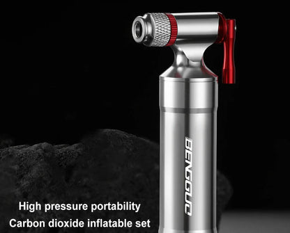 Silver and red high-pressure inflator with brand name on a dark background