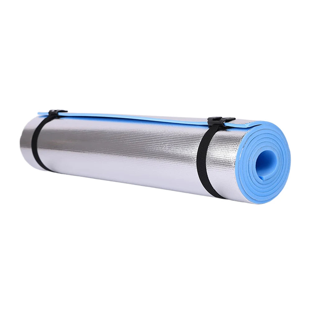 Blue yoga mat with black straps on a white background