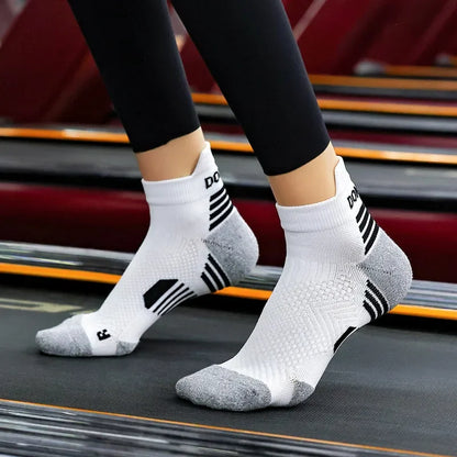 White running socks with black stripes worn on a treadmill